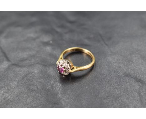 A ruby &amp; diamond chip cluster ring having an illusionary setting and 18ct gold loop, size I &amp; approx 3g