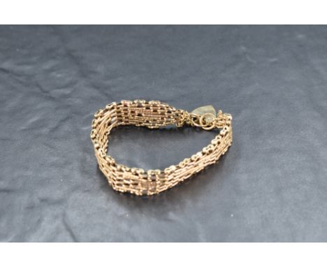 A 9ct gold multi link gate bracelet having padlock clasp, approx 29g