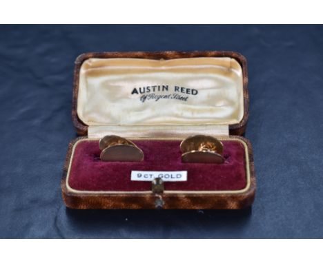 A cased pair of 9ct gold cufflinks of oval form having engine turned decoration and chain conectors, approx 4.6g