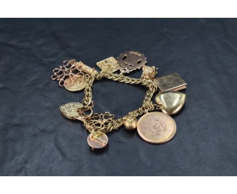 A 9ct gold double link charm bracelet having padlock clasp and twelve large charms including 1915 whist league medal, Canberr