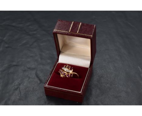 A 1990's ruby and diamond firebird ring by Franklin Mint having a central row of diamonds within two rows of pear cut rubies 