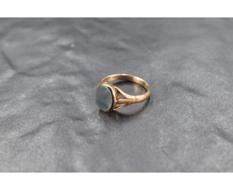 A small 9ct gold signet ring having oval blood stone panel &amp; open shoulders, size K &amp; approx 2.3g