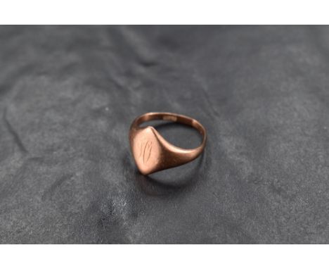 A rose gold signet ring having worn engraving to oval panel on a gold loop, marks worn, presumed 9ct, size Q &amp; approx 4.4