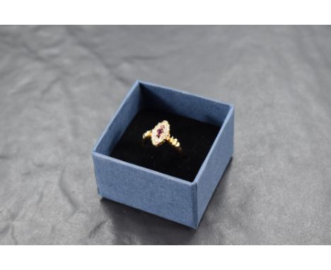 A ruby and diamond navette ring having three central rubies within a surround of old cut diamonds, having moulded shoulders o