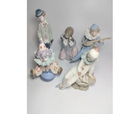 Two Lladro Clowns 17.5cm and 22cm Lladro girl with puppy 16cm, and two Nao figures , 16cm and 18cm. (5) 