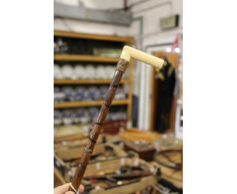 A ivory handle bamboo walking stick