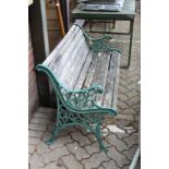 A cast metal and wooden slatted garden bench