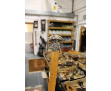 A silver topped walking stick