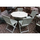 A painted octagonal shaped folding garden table and four similar chairs