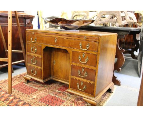 A good Georgian design mahogany kneehole desk with brushing slide single frieze drawer central cupboard flanked by three smal