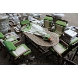 A good large patio table with parasol and six folding armchairs with cushions
