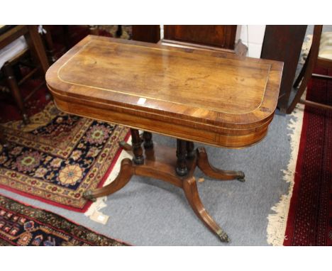 A good Regency rosewood and brass inlaid foldover card table