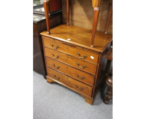 A George III mahogany small chest of drawers with brushing slide over four graduated long drawers on bracket feet