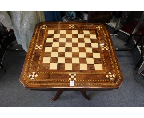 An inlaid games table on tripod base