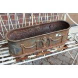 A cast iron garden trough