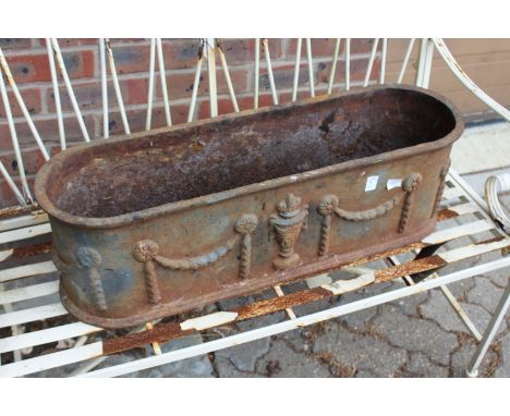A cast iron garden trough