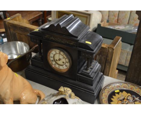 A large late Victorian black slate two hole mantel clock