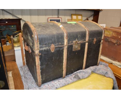 A canvas and wooden bound trunk