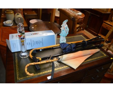 A Galileo glass thermometer with original box; a quantity of parasols and walking sticks and a continental Parion ware figure