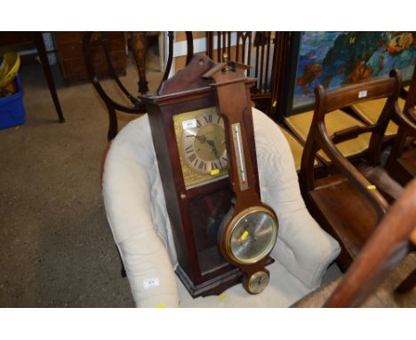 A modern barometer and a modern wall clock 