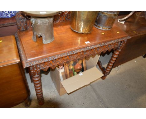 A Victorian carved oak hall table raised on bobbin turned supports