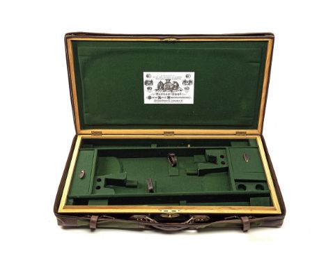 A BRASS-CORNERED OAK AND LEATHER DOUBLE UNIVERSAL GUNCASE, fitted for 33in. barrels, the interior lined with green baize, a W