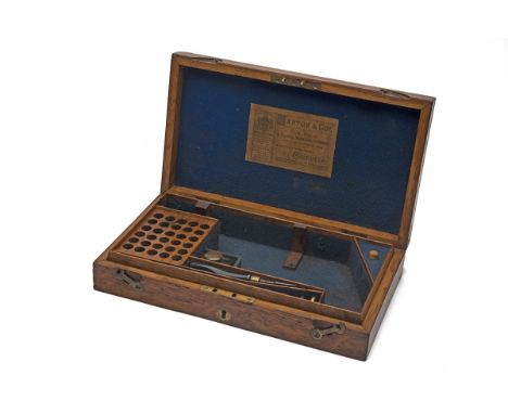 AN ENGLISH MARKET OAK PISTOL CASING FOR A LARGE-FRAME CARTRIDGE REVOLVER WITH MANTON, CALCUTTA TRADE LABEL, circa 1900, measu