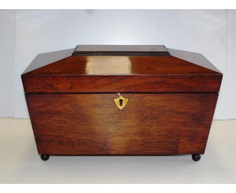 William IV rosewood sarcophagus tea caddy with brass ring handles and ball feet, rosewood interiors with twin lids and bowl r