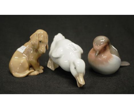 Two Bing and Grondahl animal figurines comprising #2310 a bird, and #1755 a dog, together with a Nao duck, height 8cm approx