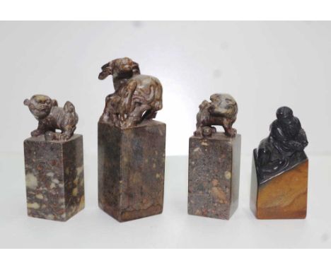 Four various Chinese carved stone seal chops including: seal with carved water buffalo finial, (height 10cm approx); and grou