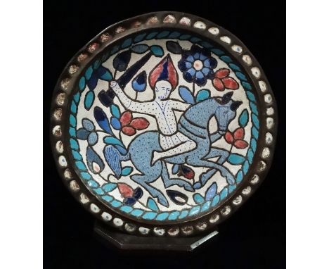 An early 20th century Persian brass and enamel charger decorated with a warrior on horseback, diameter 36cm. 