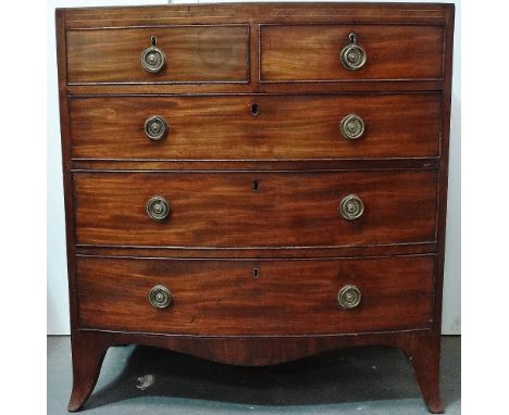 An early 19th century bow front chest of five graduated drawers raised on bracket feet with ring handles and of elegant small