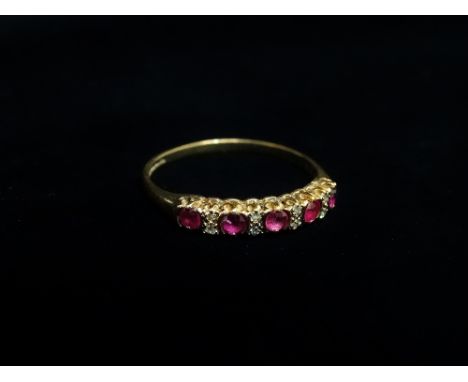 A 9ct gold ring set five rubies and eight diamonds, the diamonds of .08ct spread approximately, size R.