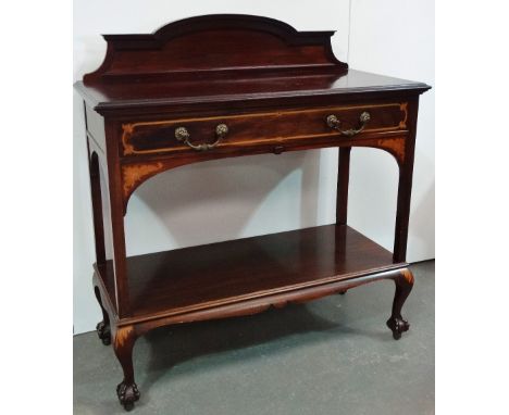 A mahogany and inlaid sideboard cabinet by Warings of London, fitted a single drawer with ormolu drop handles with lower shel