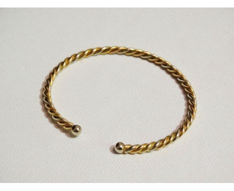 A bi colour yellow metal twisted wire bangle, weight 13.5g.