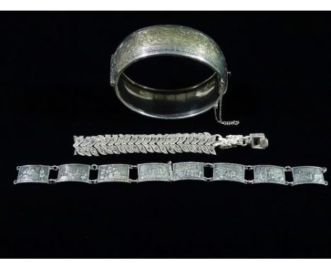 A silver bangle with engraved decoration, London 1939, together with a silver bracelet and a white metal and marcasite bracel