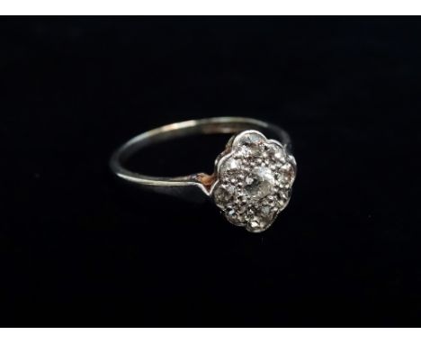 A 18ct gold and platinum nine stone diamond set ring, the diamonds of .21ct spread approximately, size M.