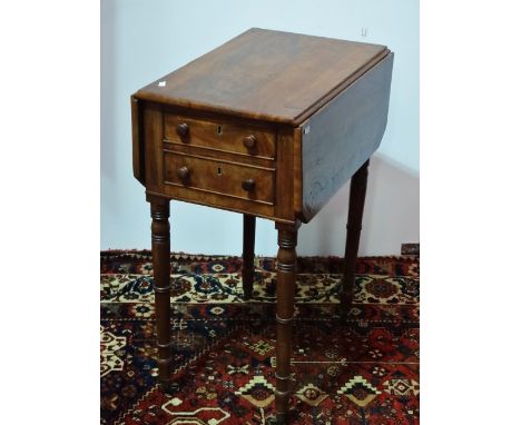 A 19th century mahogany and crossbanded drop leaf work table, fitted two drawers above ring turned legs capped with brass cas