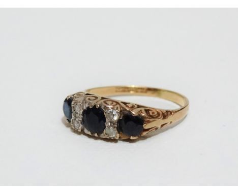 A 9ct diamond and sapphire ring, the shoulders with chased decoration, size Q.