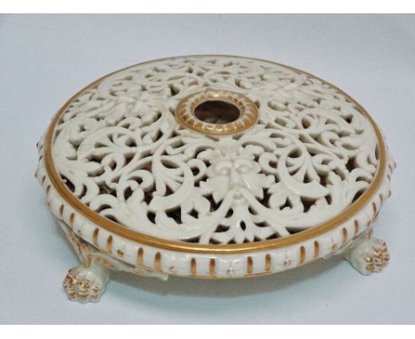 A Grainger and Co. Worcester porcelain potpourri, the pierced top with face masks and scrolling acanthus raised on three claw