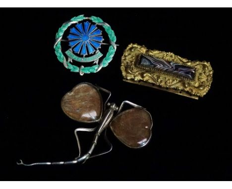 An Art Nouveau style silver brooch modelled as a dragonfly, a silver and enamel brooch and a gilt metal and agate brooch. 