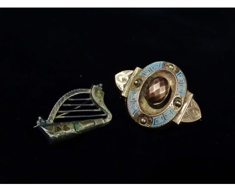 A Victorian rose gold and enamel brooch, together with a silver brooch modelled as an Irish harp decorated with shamrocks. 