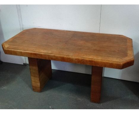 A 1930s Art Deco walnut octagonal shaped dining table raised on twin pillar supports, 155 x 79cm.