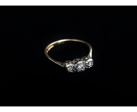 A 9ct gold diamond illusion set three stone ring, size K.