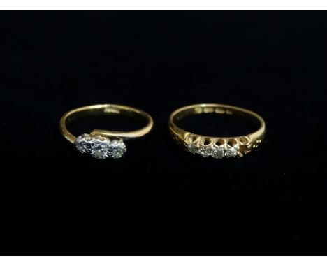 A 9ct gold three stone diamond ring, the diamonds of .09ct spread approximately, size K, together with an 18ct gold and diamo