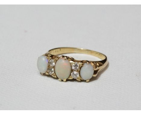 An 18ct gold ring set opals and diamonds, size O.