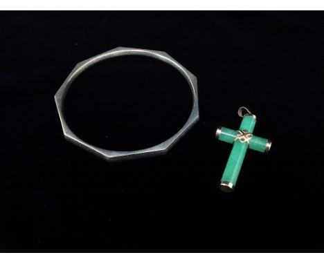 A jade and 14ct gold mounted crucifix, together with a silver faceted bangle. 