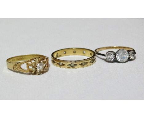 A 9ct gold eternity ring set diamond chips, size Q, together with two other 9ct gold, silver and stone set rings. 