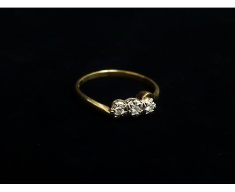 A 9ct gold illusion set three stone diamond ring, the diamonds of .06ct spread approximately in total, size T.