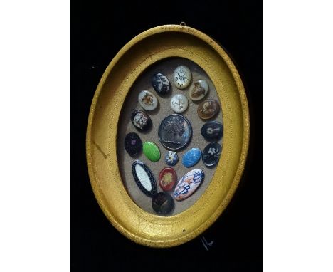 A good collection of eighteen 19th century buttons and covers, framed as one, including enamel, mother of pearl and painted g